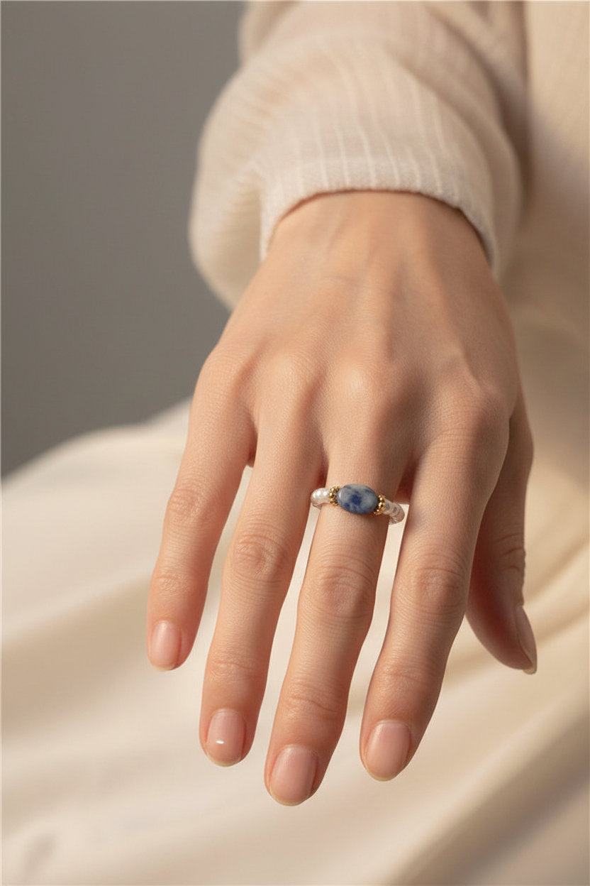 Older woman wearing pearl ring close-up